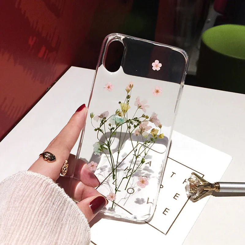 Handmade clear epoxy flower iPhone case with real dried flowers on soft TPU back cover.