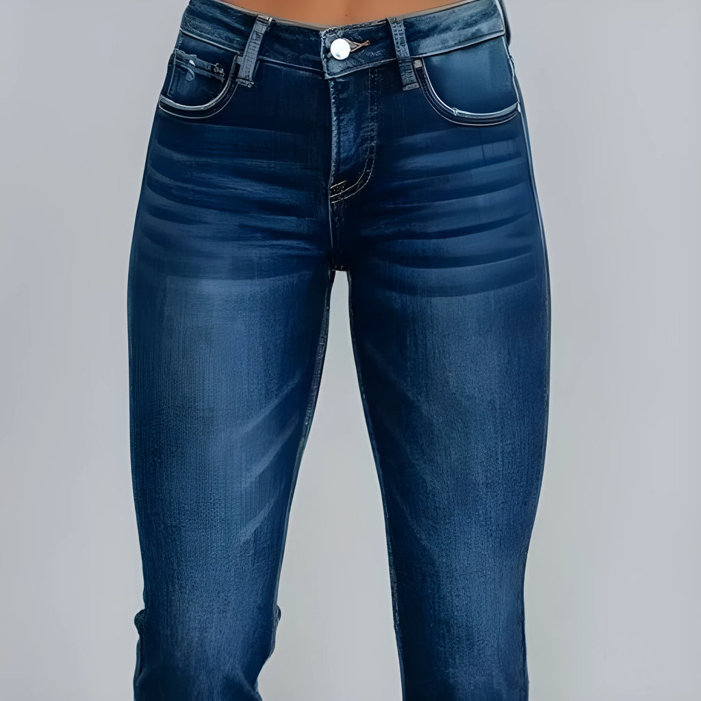 Women's solid colour denim jeans with a hand-worn distressed finish in dark blue.
