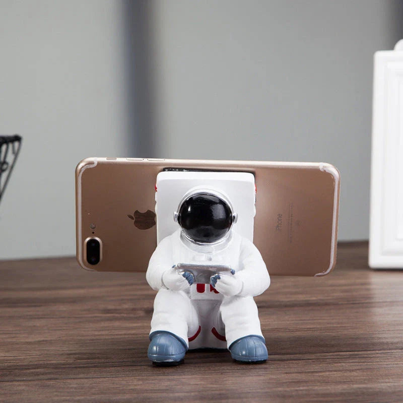 Astronaut-themed resin phone stand with unique design for desk decoration