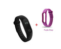 Black Xiaomi Mi Band 2 fitness tracker on wrist showing OLED screen with heart rate data.