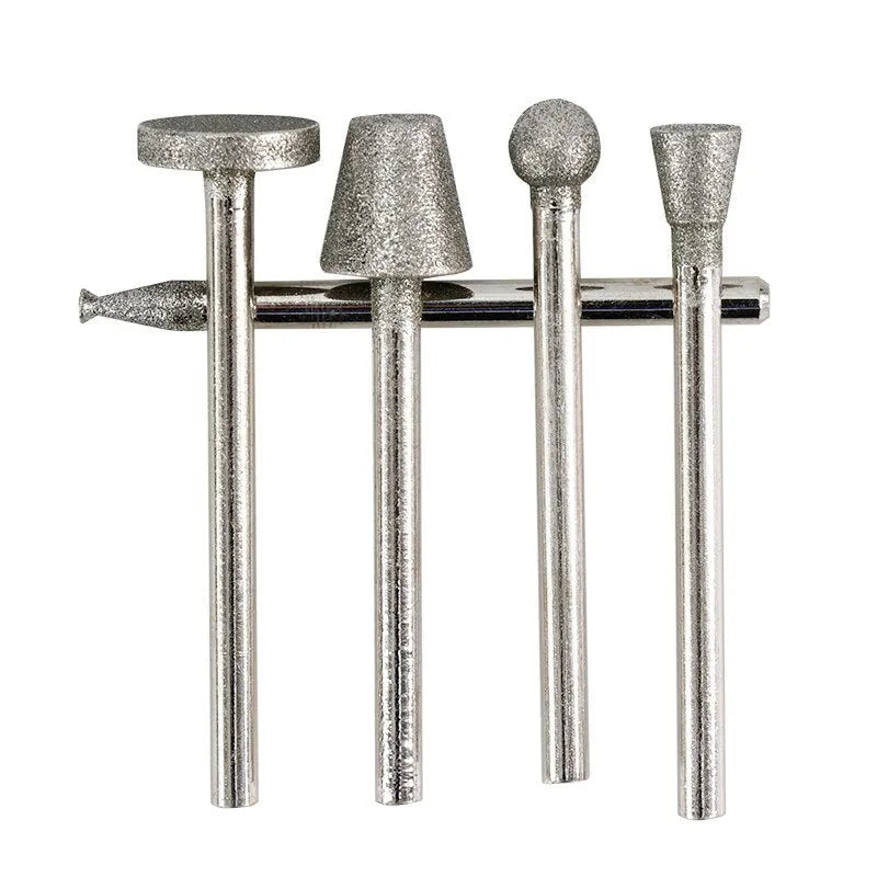Set of alloy grinding heads with elliptical cone diamond and golden diamond tips on a white background.