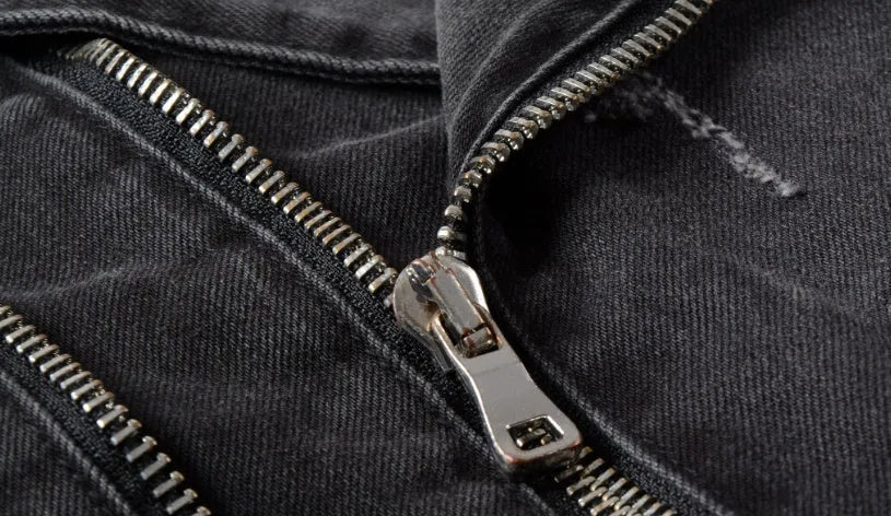 Black slim-fit linen denim jacket with lapel collar and front zipper placket on plain background