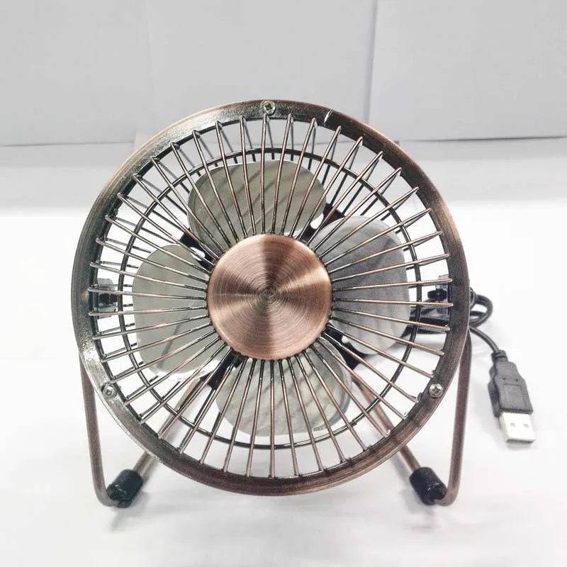 4-inch metal USB mini fan in bronze colour with rocker switch on desk