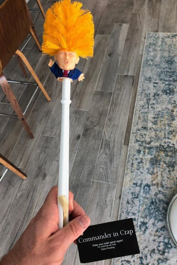 Bright yellow Trump-themed toilet brush with hanging slot