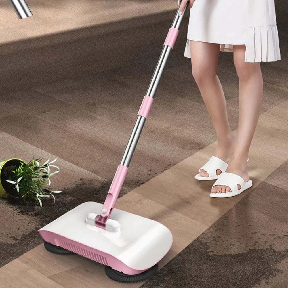 Pink hand push sweeper 3-in-1 with rotating brush on tiled floor