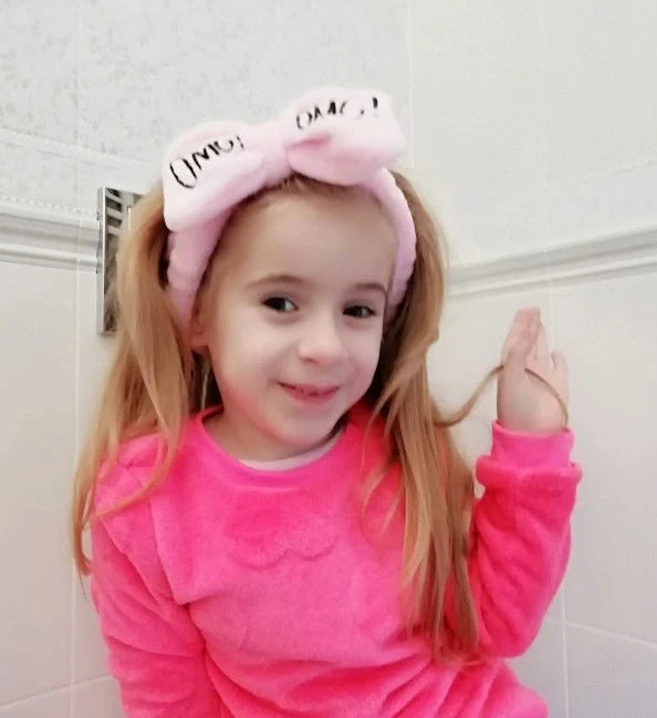 Coral velvet butterfly end hair band in pink with text styling, showing butterfly ends and cloth material