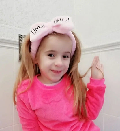 Coral velvet butterfly end hair band in pink with text styling, showing butterfly ends and cloth material