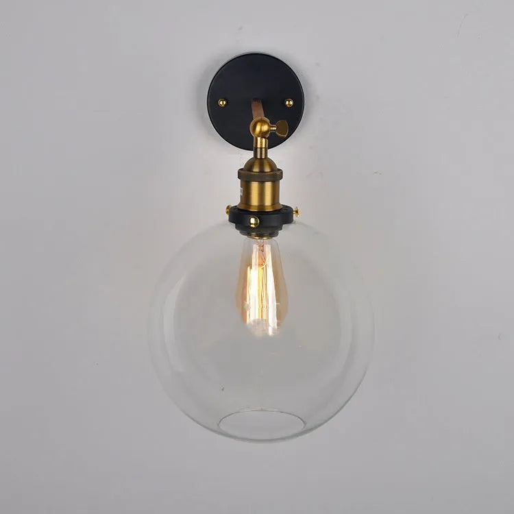 Round retro glass ball wall lamp in amber, smoke grey, or transparent finish with aluminium holder.