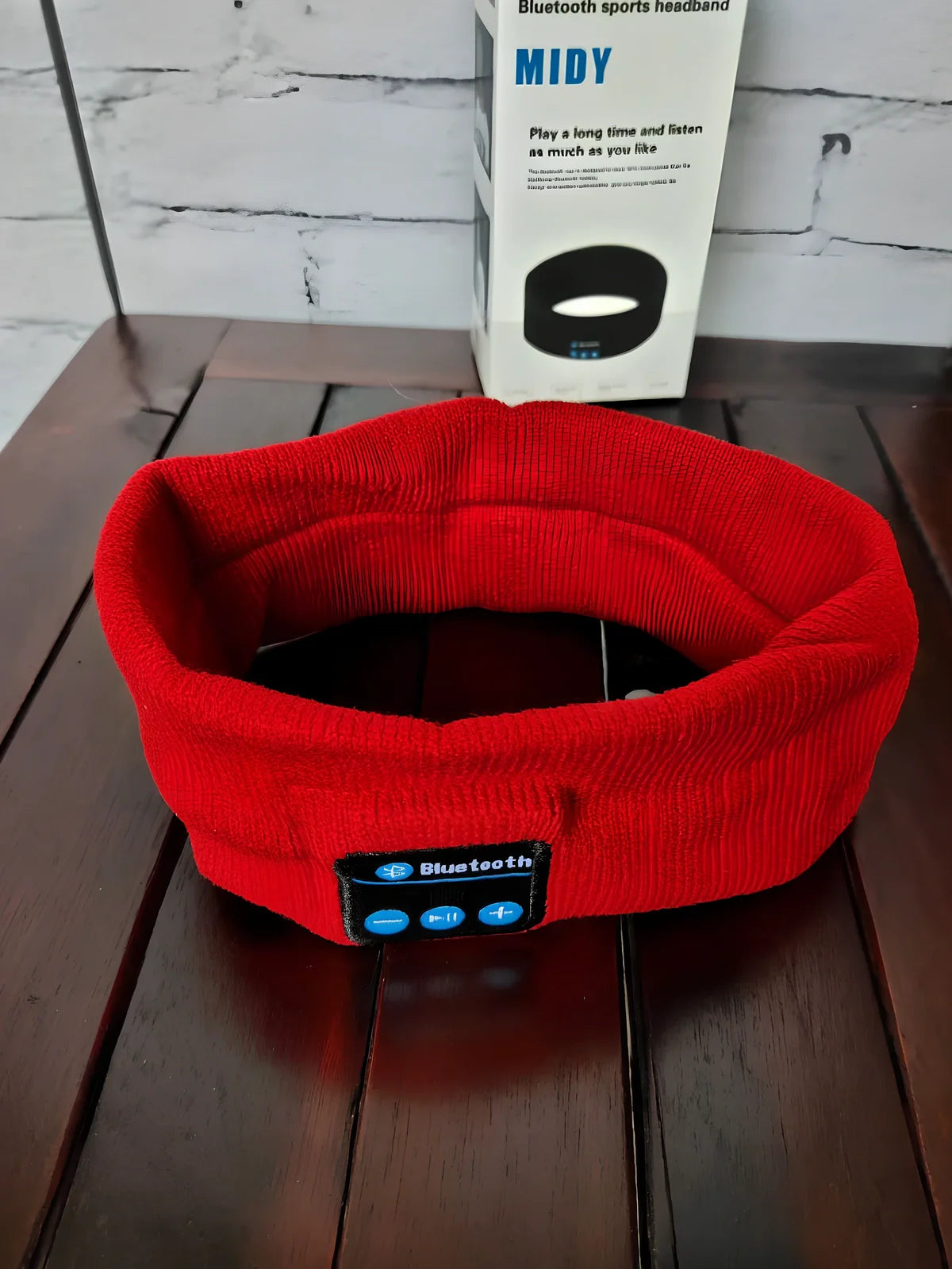 Black Bluetooth sports headband with integrated audio controls and 110mAh battery for workouts