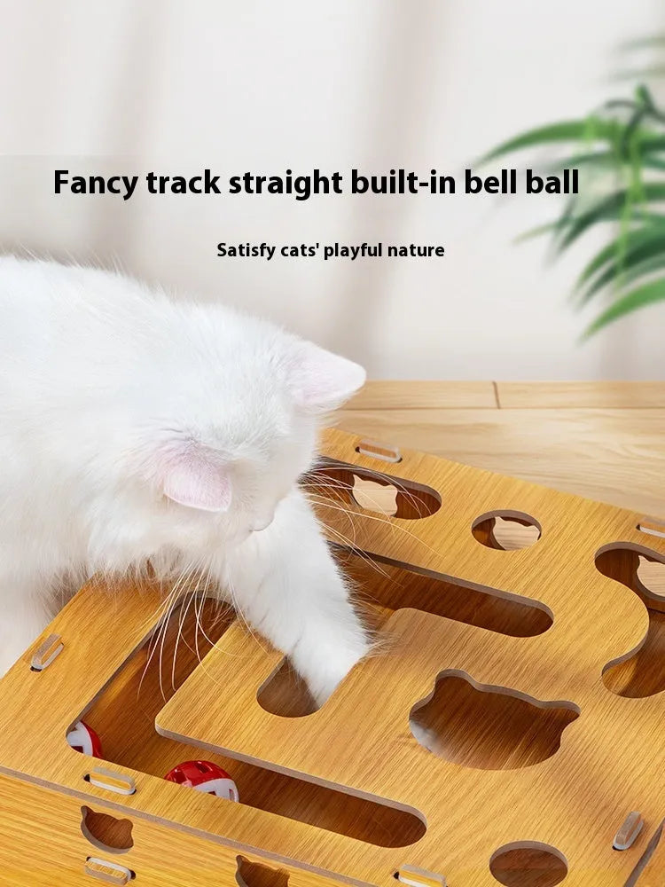 Wooden cat maze box with teasing stick and two bell balls on a floor