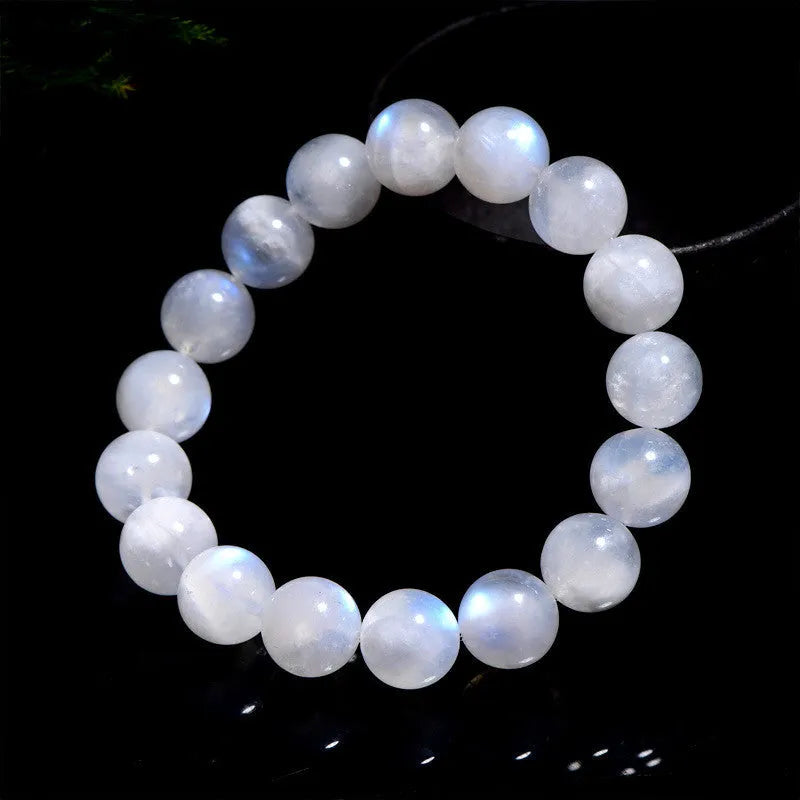 Natural blue moonlight round bead moonstone bracelet in white, showing polished stone surface.