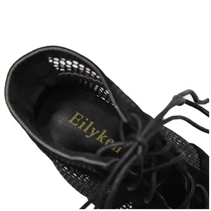 Black suede women's lace-up high heel shoes with a stiletto heel on a plain background