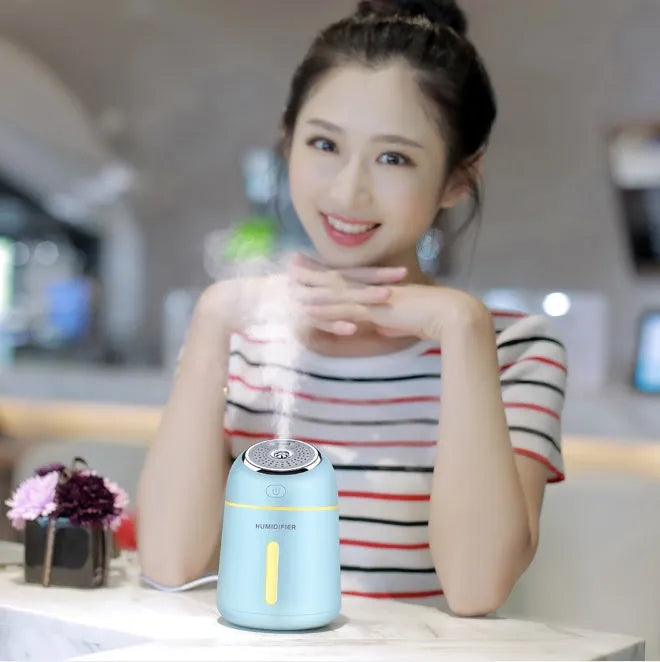 Mini ultrasonic humidifier 330ml four-in-one USB with LED light and fan in blue, pink and white on desk