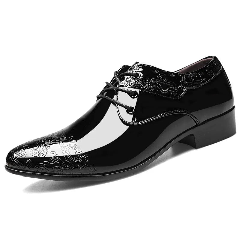Glossy black men's formal shoes with pointed toe, low top, and carved detail on microfiber leather upper