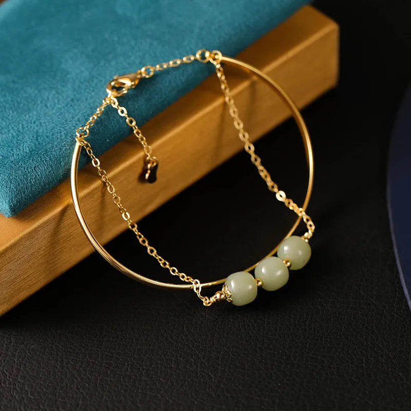 Women's jade bracelet with gold inlay detailing showing single bead version