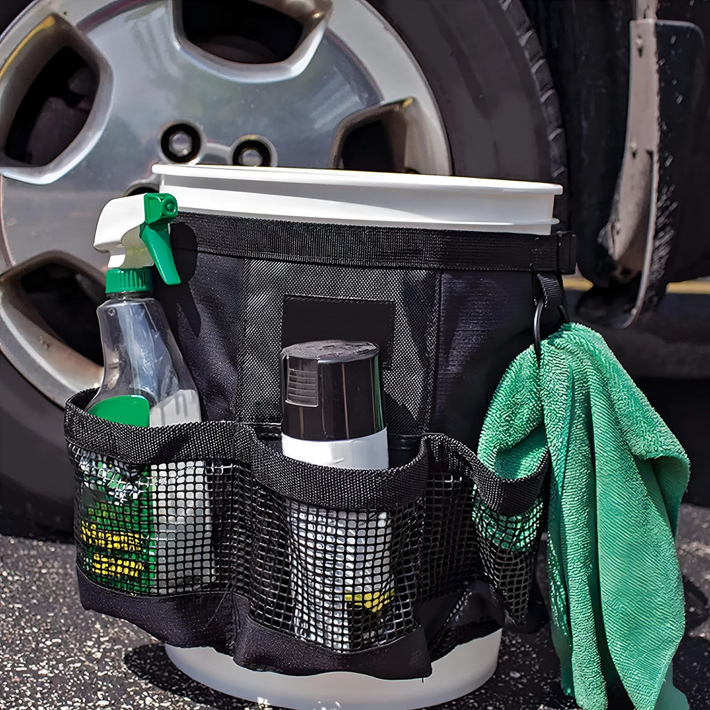 Black cylindrical polyester hanging storage bag designed to fit on a 5-gallon bucket for tool organisation.