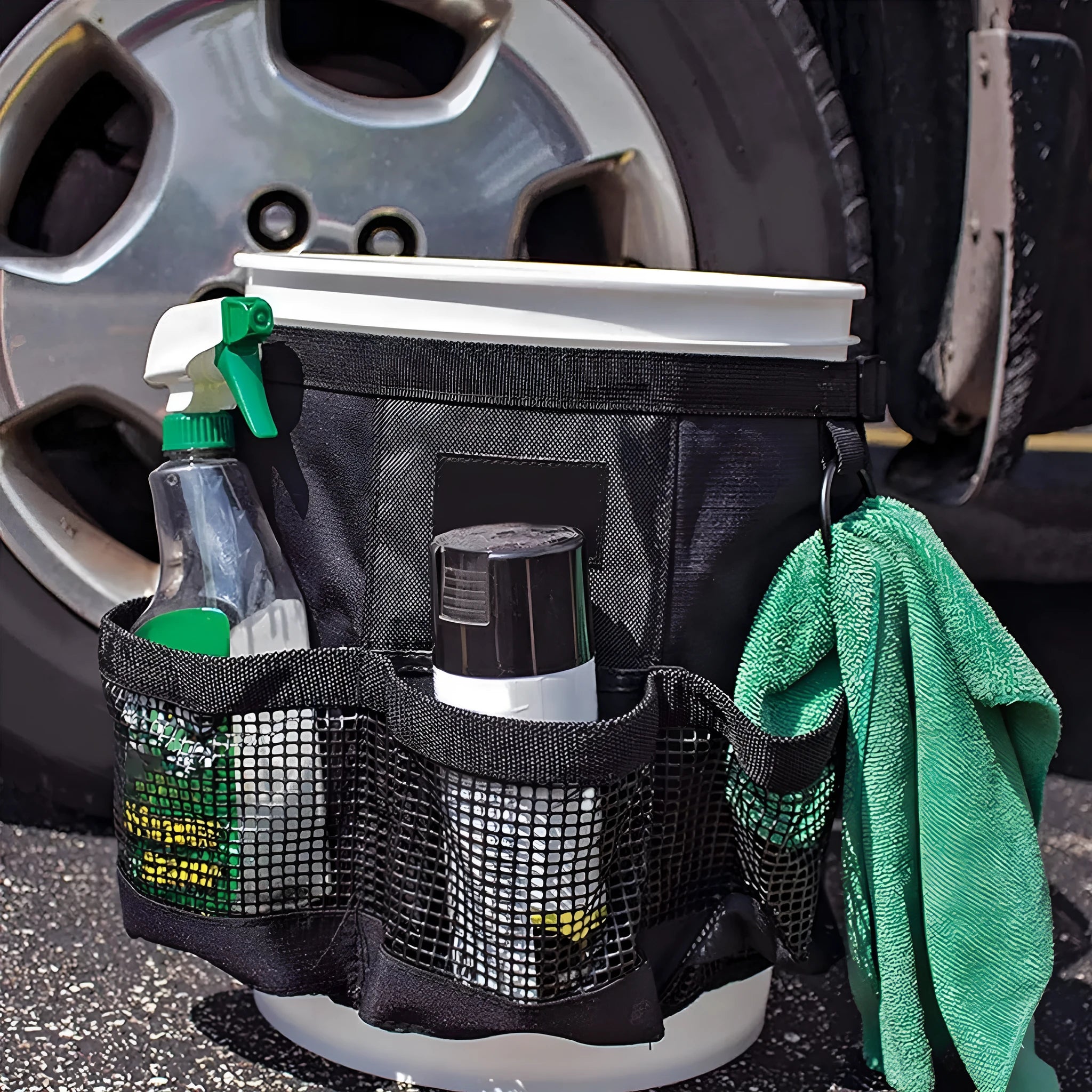 Black cylindrical polyester hanging storage bag designed to fit on a 5-gallon bucket for tool organisation.