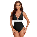 Women's solid colour cross shoulder one-piece swimsuit on a mannequin.