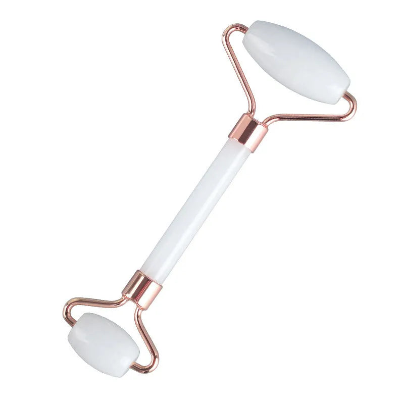 White jade double-headed facial roller and matching gua sha board set on a plain background.