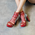 Black fish mouth high-top shoes with a cracked snake skin upper and a thick Roman block heel on a rubber sole.