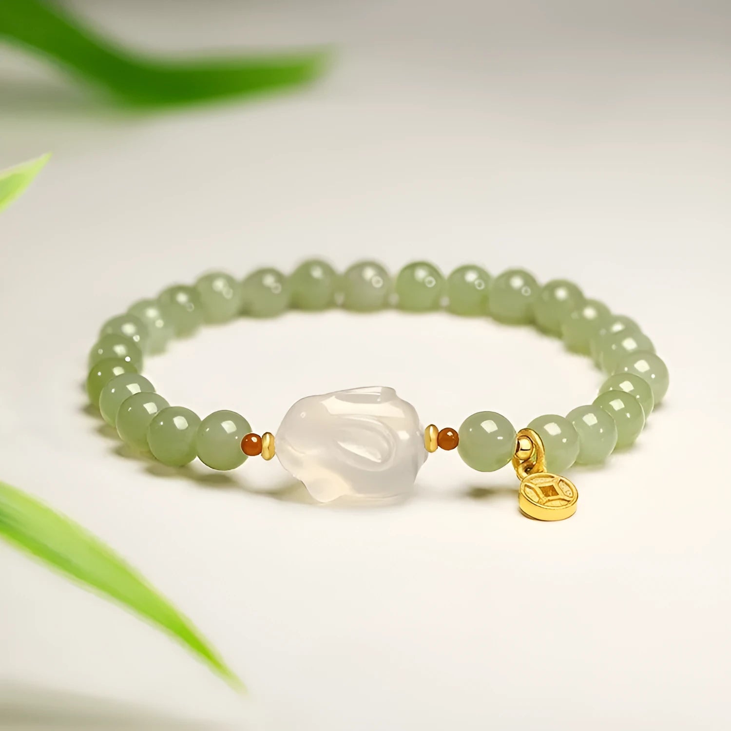 Handmade Hetian jade rabbit bracelet for women in glass with sweet rabbit charm on wrist.