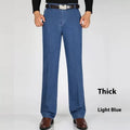 Men's high-waist loose-fit blue denim jeans on a hanger, showing the zip fly and relaxed leg cut.