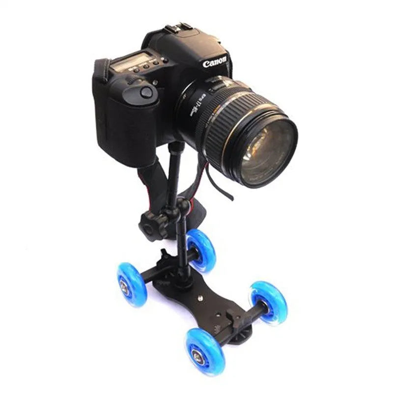 Blue dolly slider camera pulley car with solid aluminium floor, dual bearing rubber wheels, and 11inch arm on a desktop