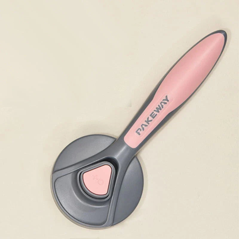 Ergonomic pet grooming brush in mint green, cherry blossom powder, and gentleman grey