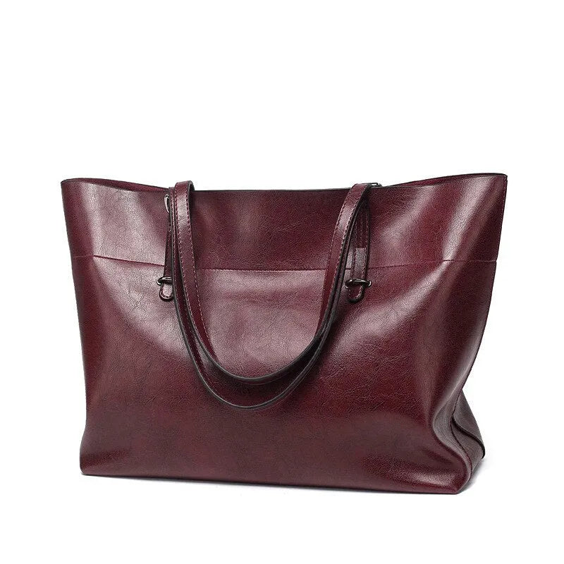 Brown cowhide leather cross body ladies handbag showing two main compartments and internal phone pouch.