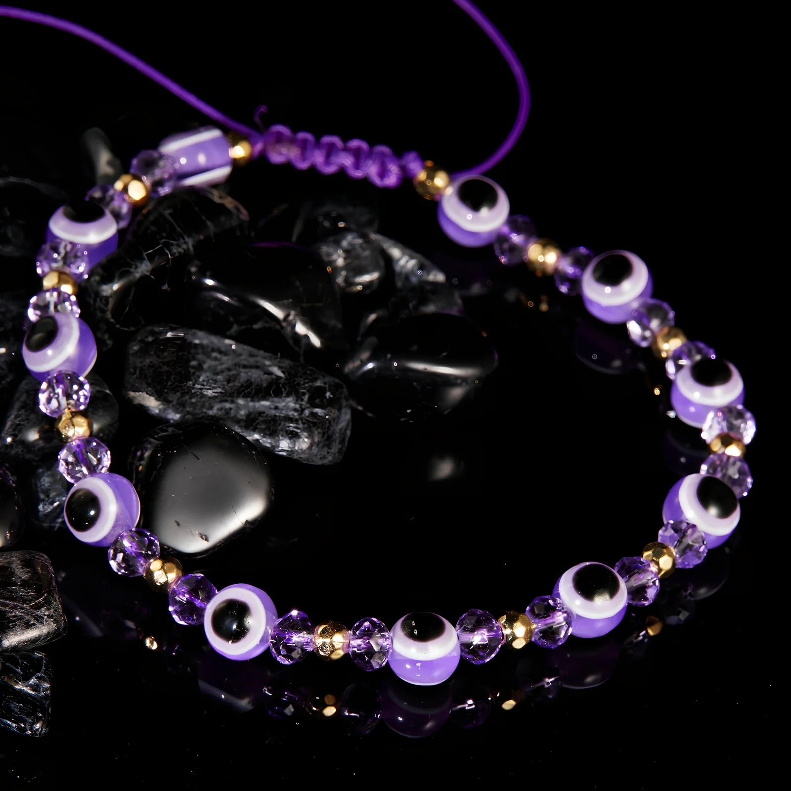 Adjustable crystal bead bracelet with blue eye design on braided rope, fits 15-19cm wrists