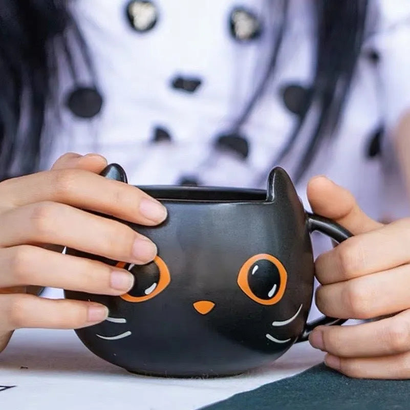 Black ceramic cat-shaped mug with pumpkin spoon couple design, 355ml capacity.
