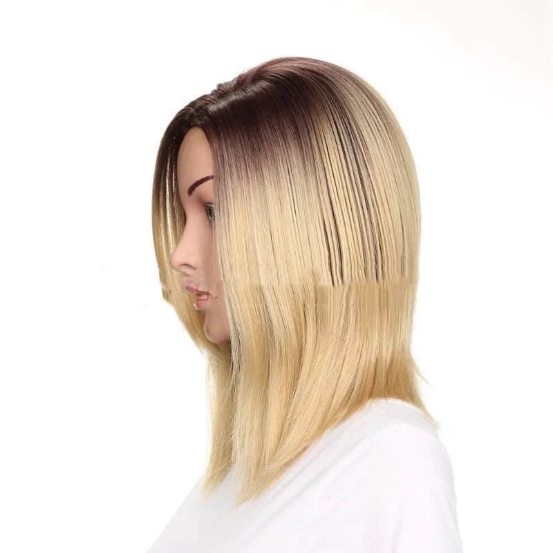Short straight wig in gold colour, 16 inch length, on a mannequin head