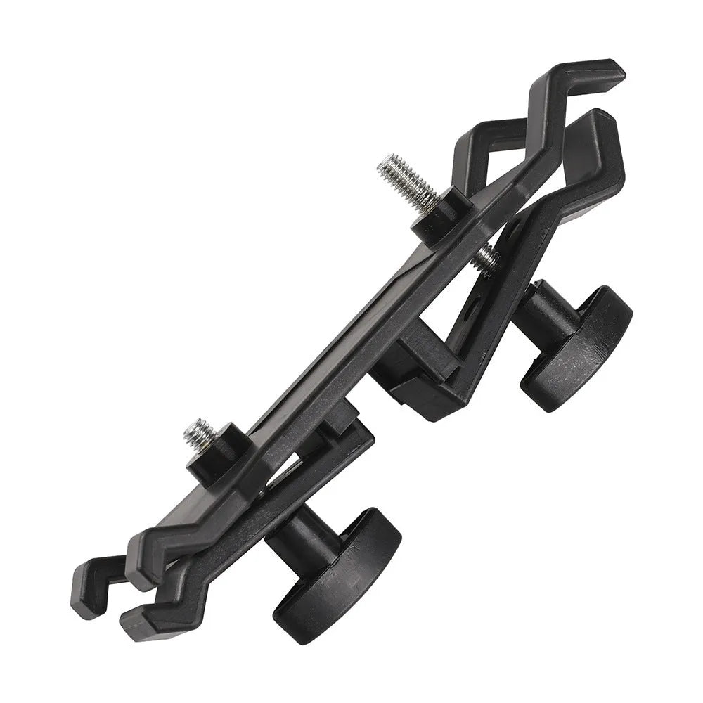 Black ABS plastic umbrella clip attached to a camera tripod shaft holding a compact umbrella.