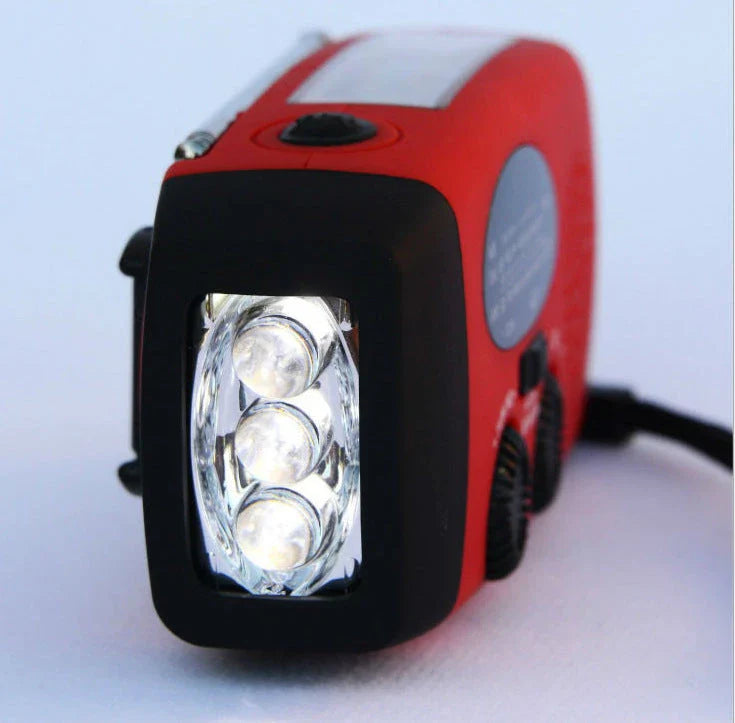 Red solar hand crank USB charging radio flashlight with AM/FM radio and LED light