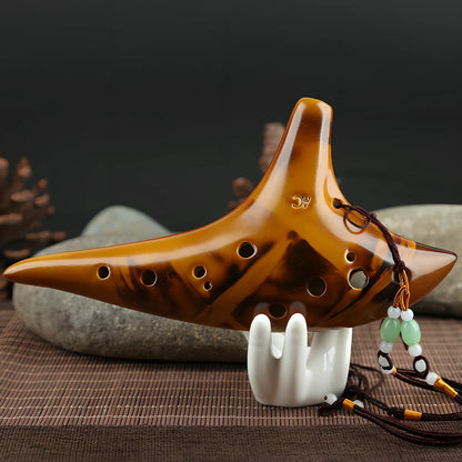 Yellow 12-hole ceramic ocarina in Alto C with 13-note range and integrated lanyard