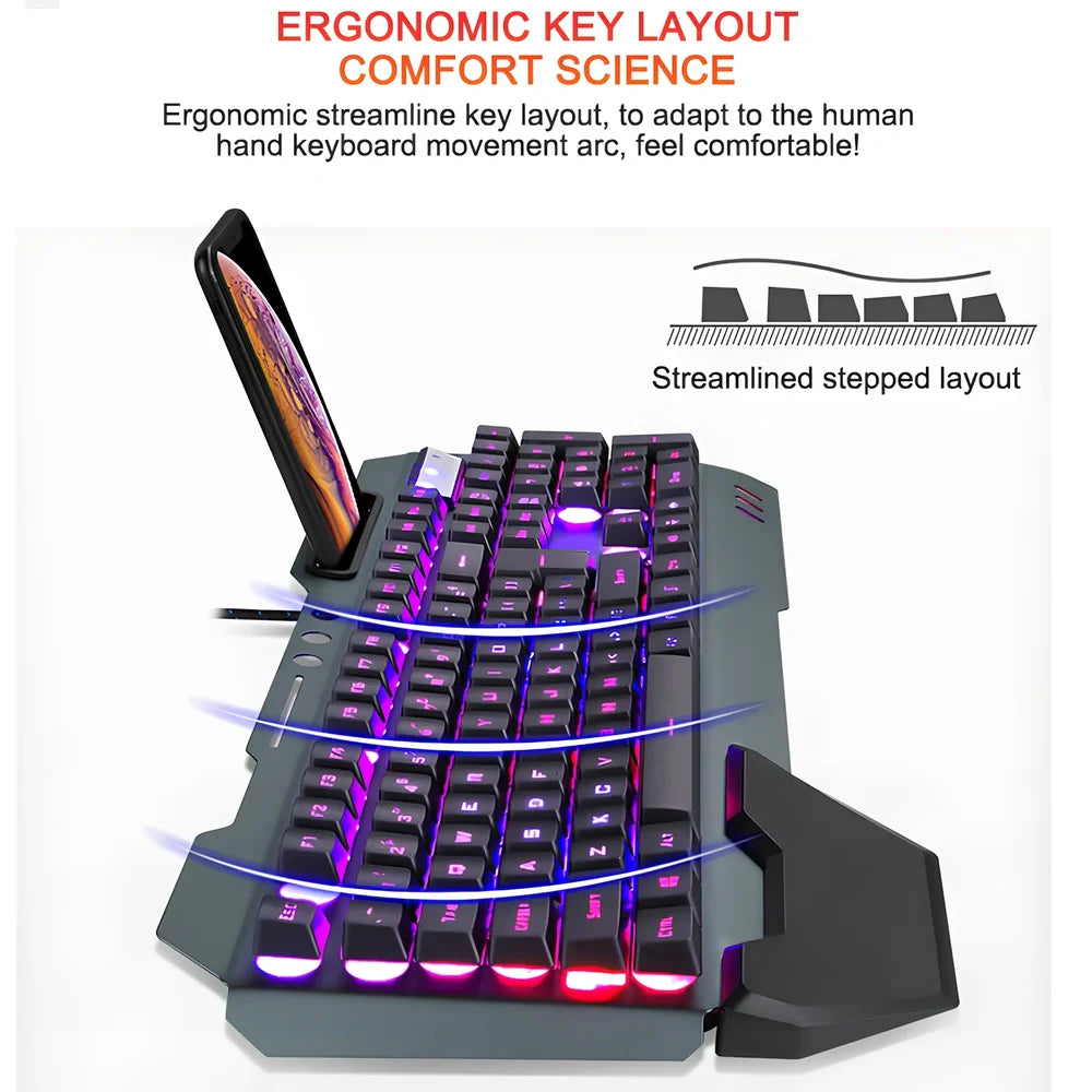 Black wired gaming keyboard with RGB backlight, phone holder, and magnetic wrist rest on desk