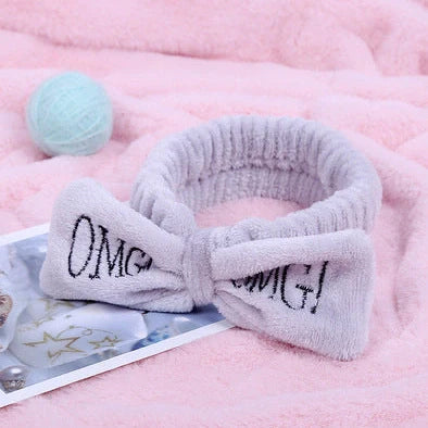 Coral velvet butterfly end hair band in pink with text styling, showing butterfly ends and cloth material