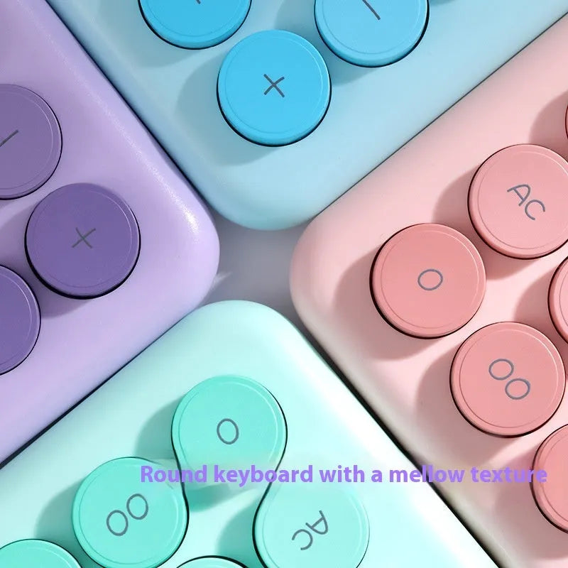 Desktop calculator with gradient colour finish in violet, blue, mint, or pink on a desk.
