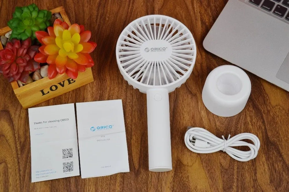 White ORICO FH1 portable USB rechargeable desk fan with three-speed buttons and a fine line pattern on its ABS shell.