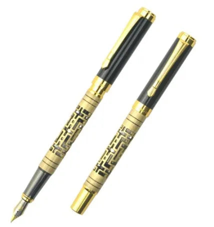 Yellow bronze metal fountain pen with iridium nib, 0.7mm big point, and gold trim, lying on a light surface
