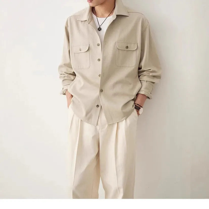 Men's light sand rice coloured casual shirt with simple lapel and long sleeves on a hanger.
