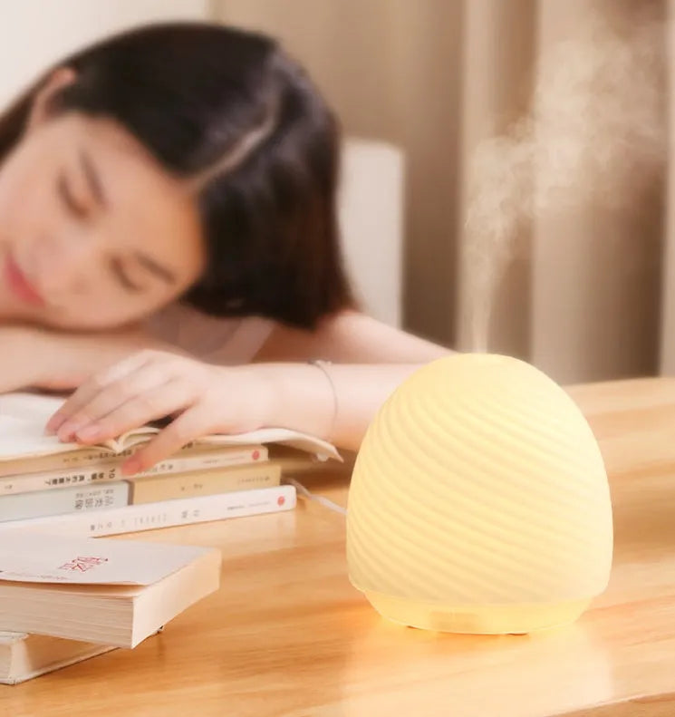 Asakusa threaded glass aroma diffuser in frosted white on a table with a single fog outlet