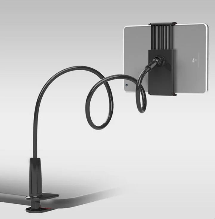 Black oversize flat panel phone stand with a long adjustable arm on a wooden table.