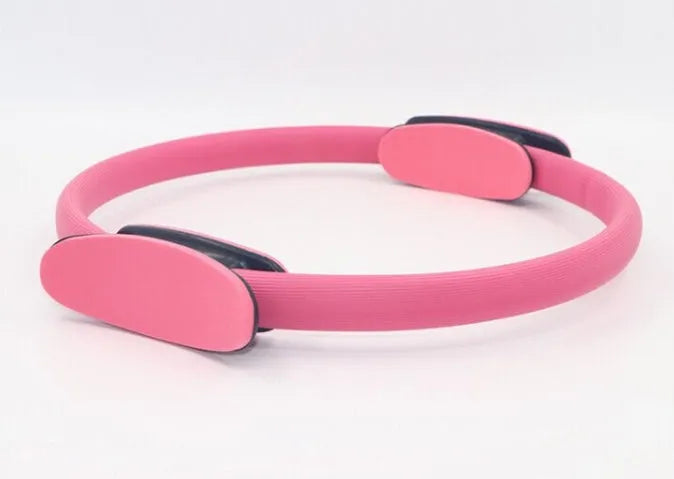 Pink Pilates ring with ergonomic curve on floor for core strength and posture exercises