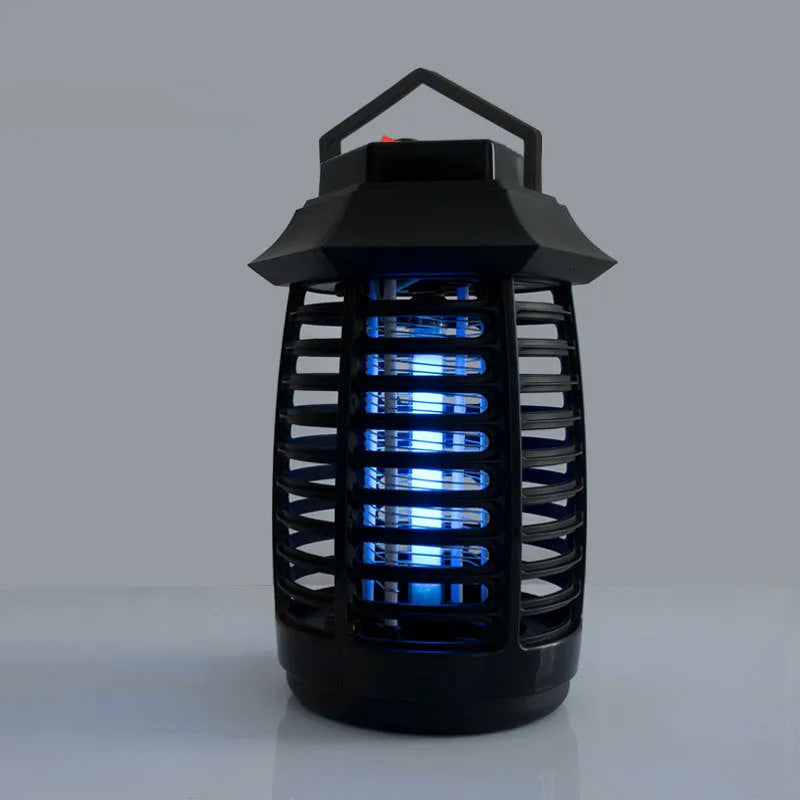 Black aromatherapy mosquito lamp with a choice of plug styles for AU, EU, UK, or US sockets on a surface.