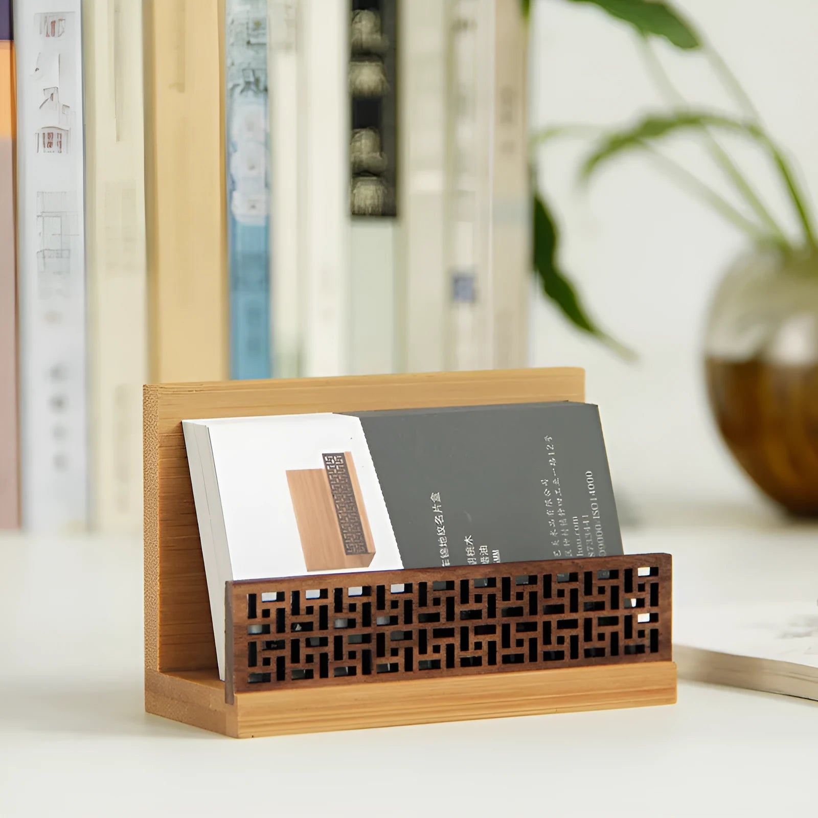 Geometric bamboo and black walnut business card holder on a desk