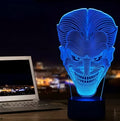 A 3D acrylic LED table lamp displaying colourful light patterns, with a remote control and USB cable.