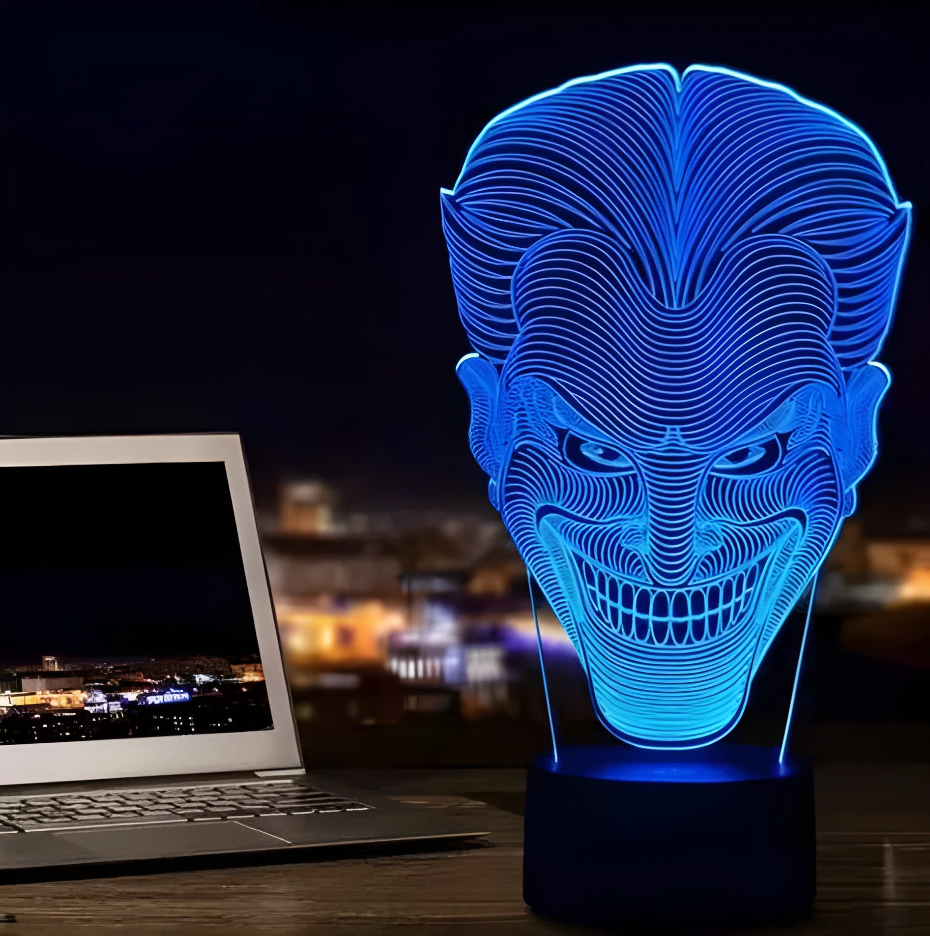 A 3D acrylic LED table lamp displaying colourful light patterns, with a remote control and USB cable.