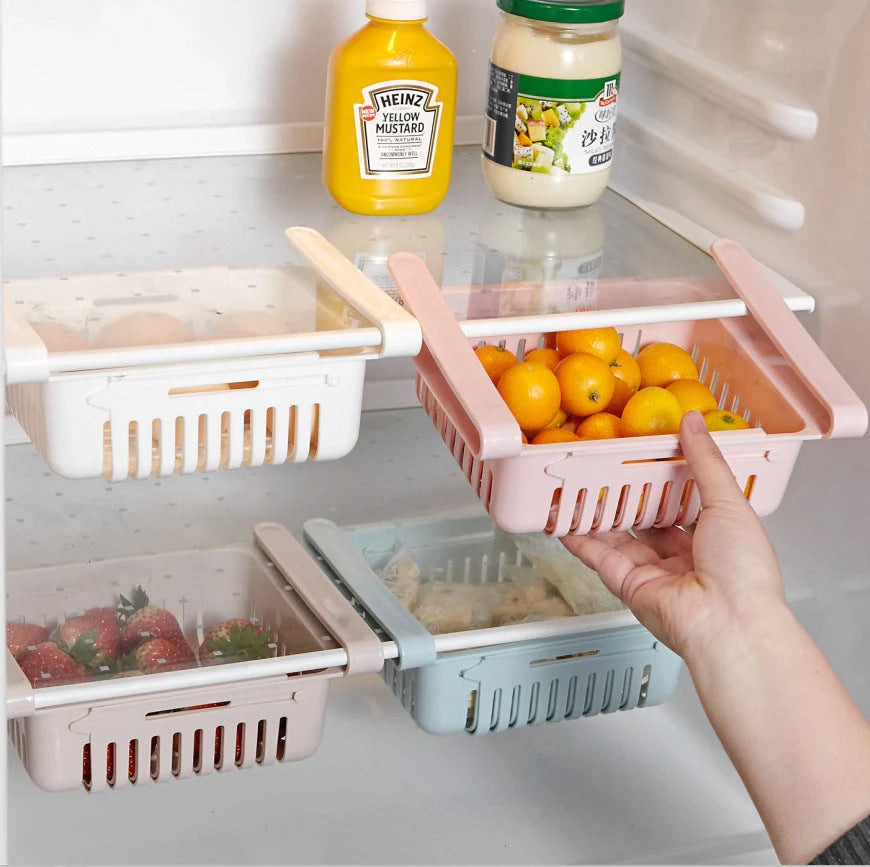Stretchable refrigerator storage basket in white, blue, pink, and apricot colours