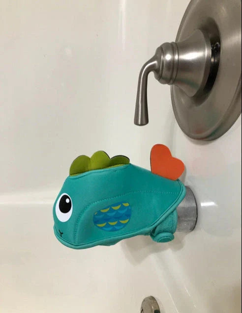 Whale-shaped bath tap safety cover with adjustable closure, designed to protect baby's head during bathtime